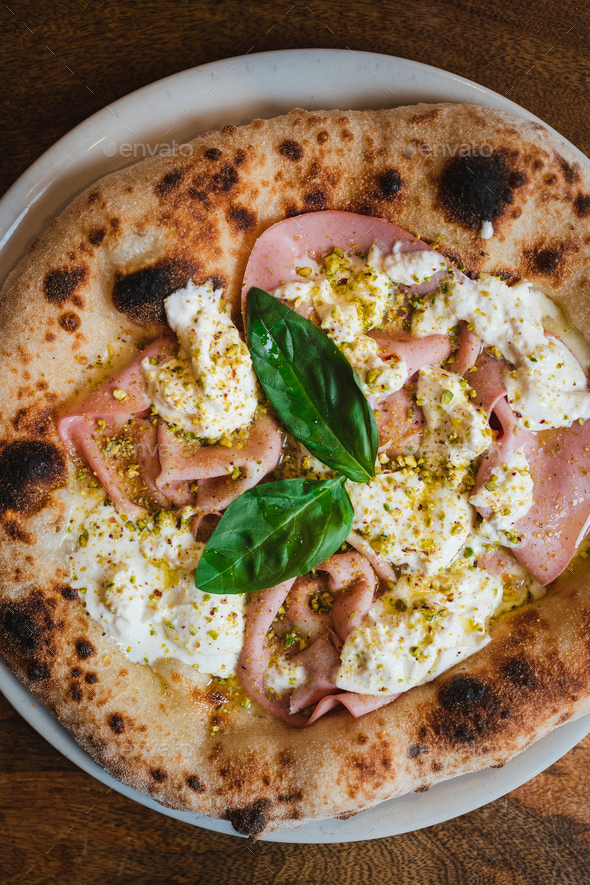Top view of an authentic italian pizza. It has mozzarella, burrata